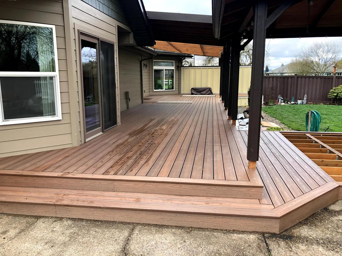 A wraparound composite deck with a wide step and a covered section