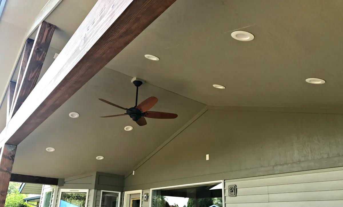 Under a covered patio: recessed lights and a ceiling fan