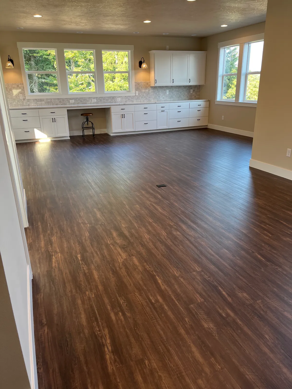 The new craft room: white custom cabinetry, a work desk and new flooring