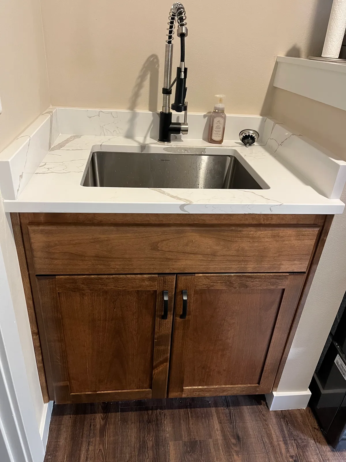 The new craft room: white custom cabinetry, a work desk and new flooring