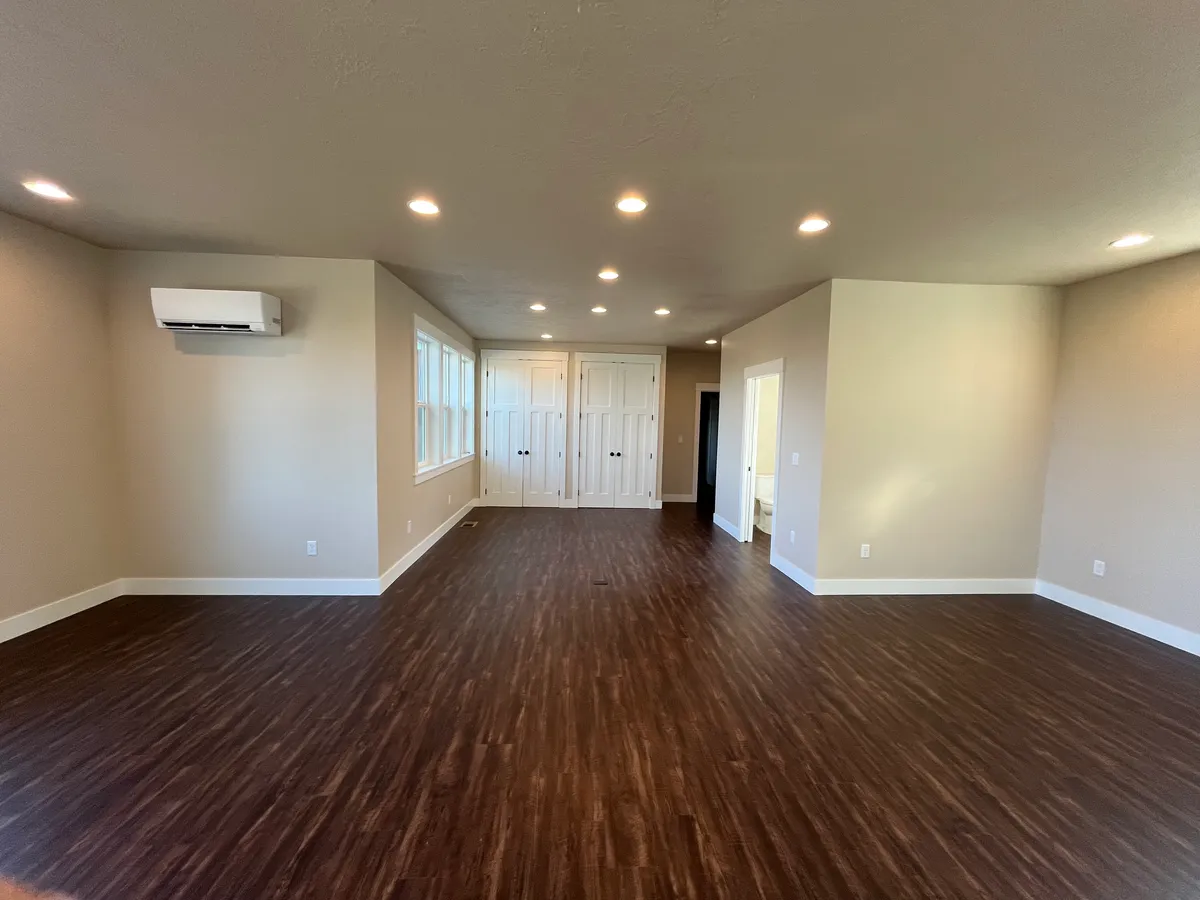The new craft room: white custom cabinetry, a work desk and new flooring