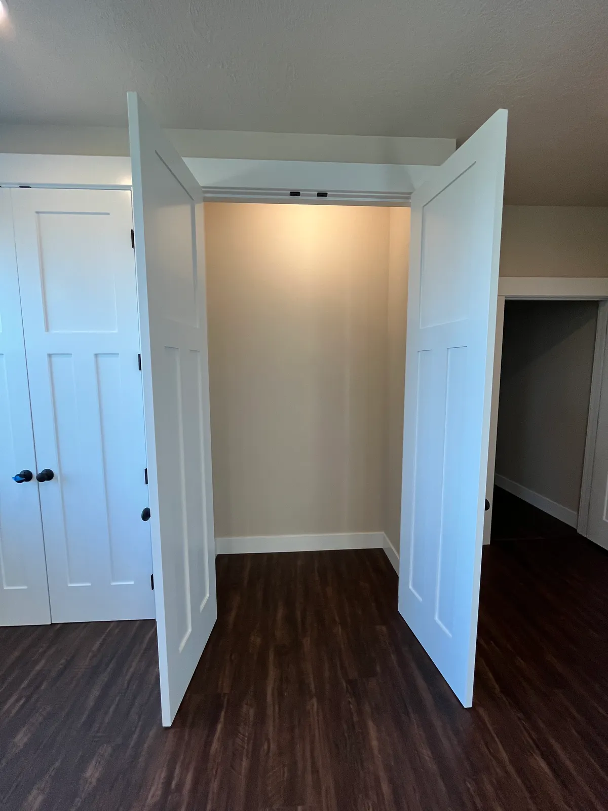 The new craft room: white custom cabinetry, a work desk and new flooring