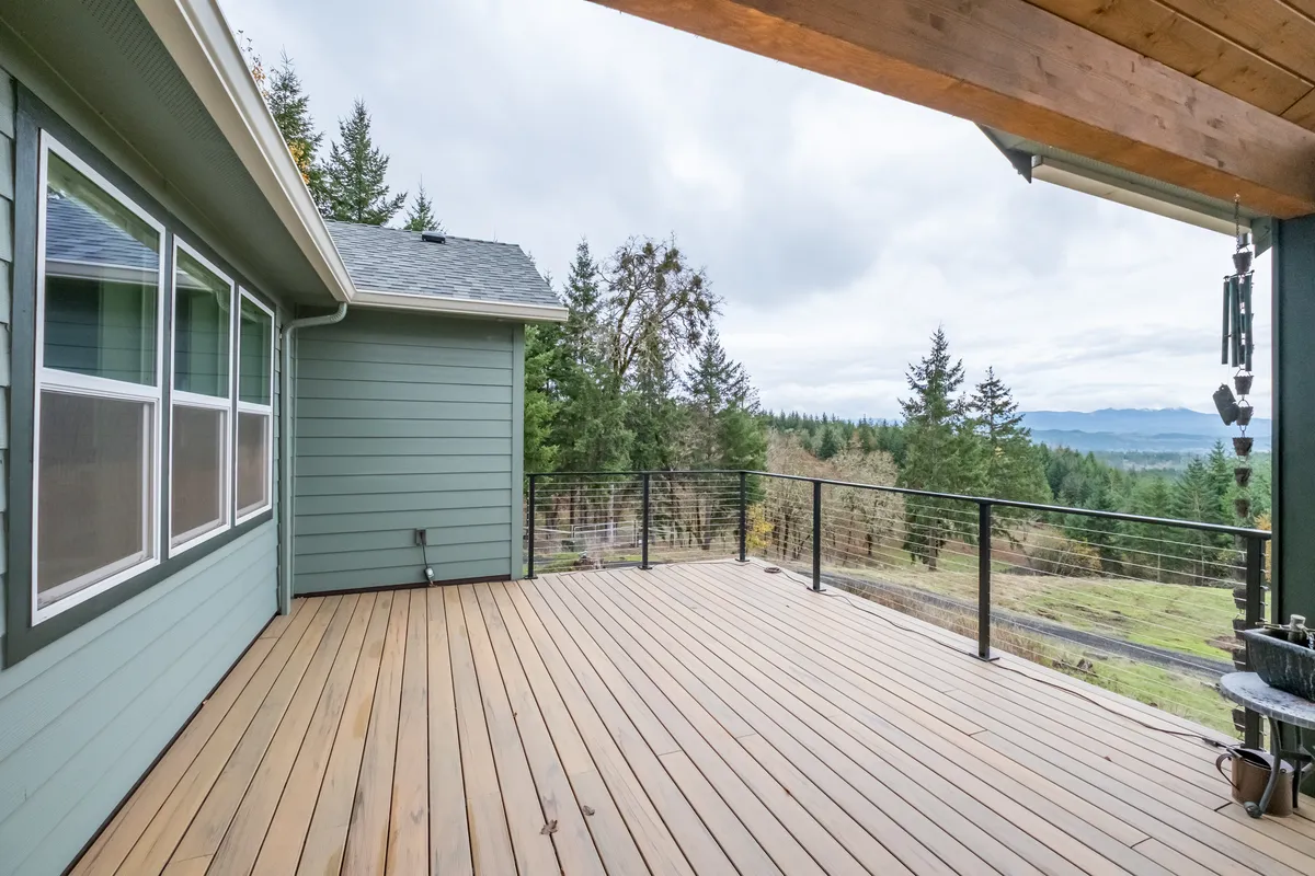 The expanded deck with braided cable railing and valley views