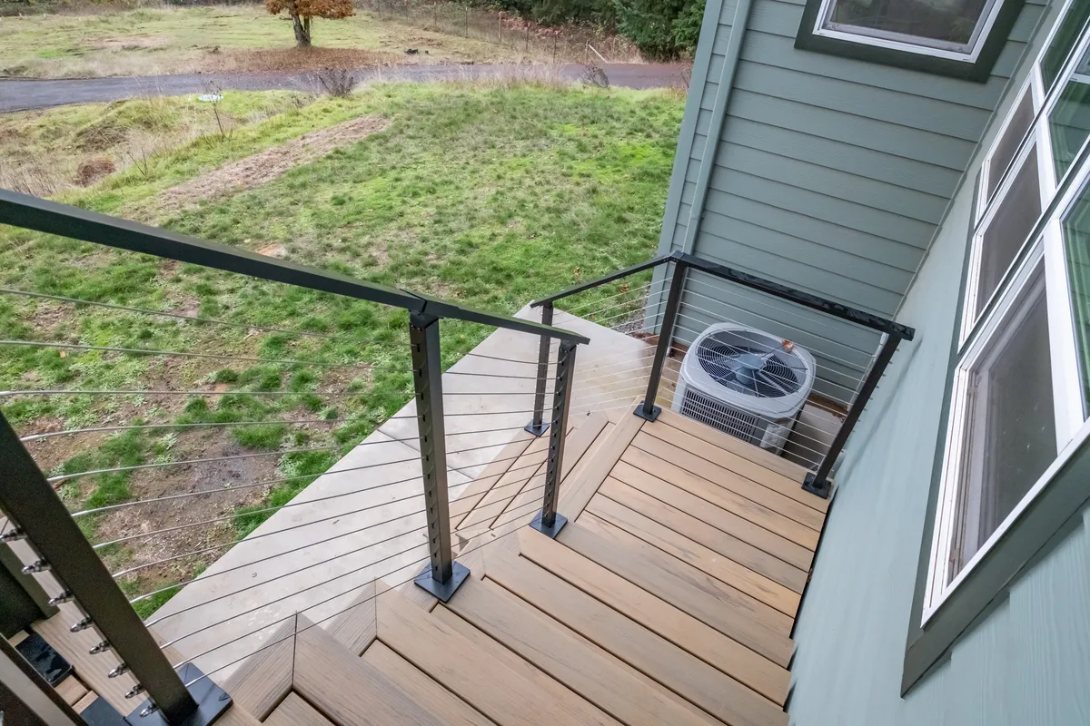 The expanded deck with braided cable railing and valley views
