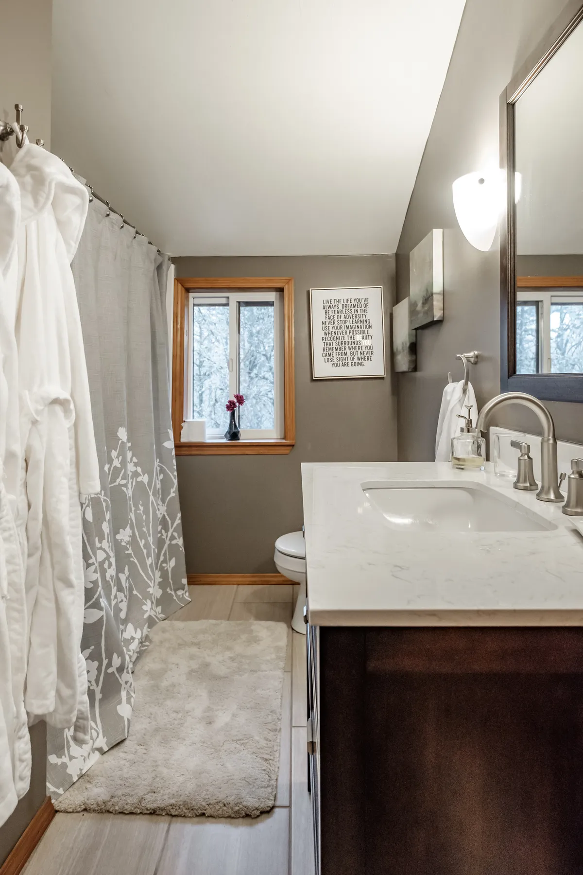 The refreshed Corvallis bathroom with a dark vanity and natural light