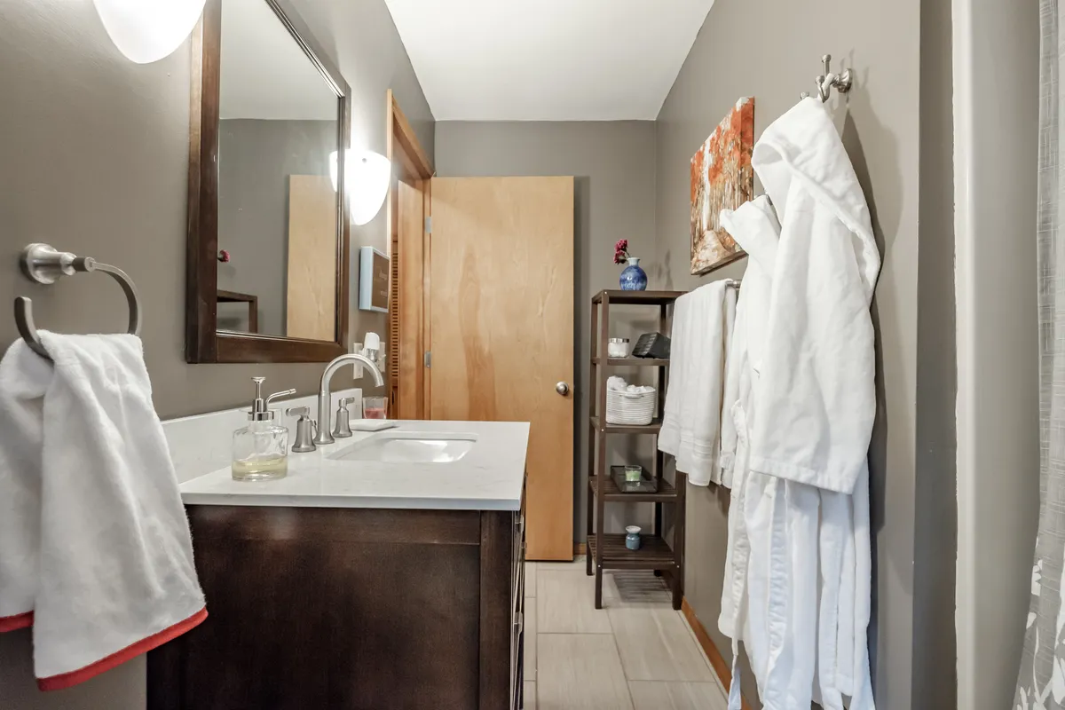 The refreshed Corvallis bathroom with a dark vanity and natural light