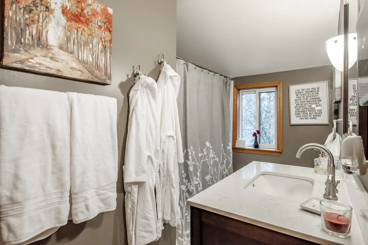 The refreshed Corvallis bathroom with a dark vanity and natural light