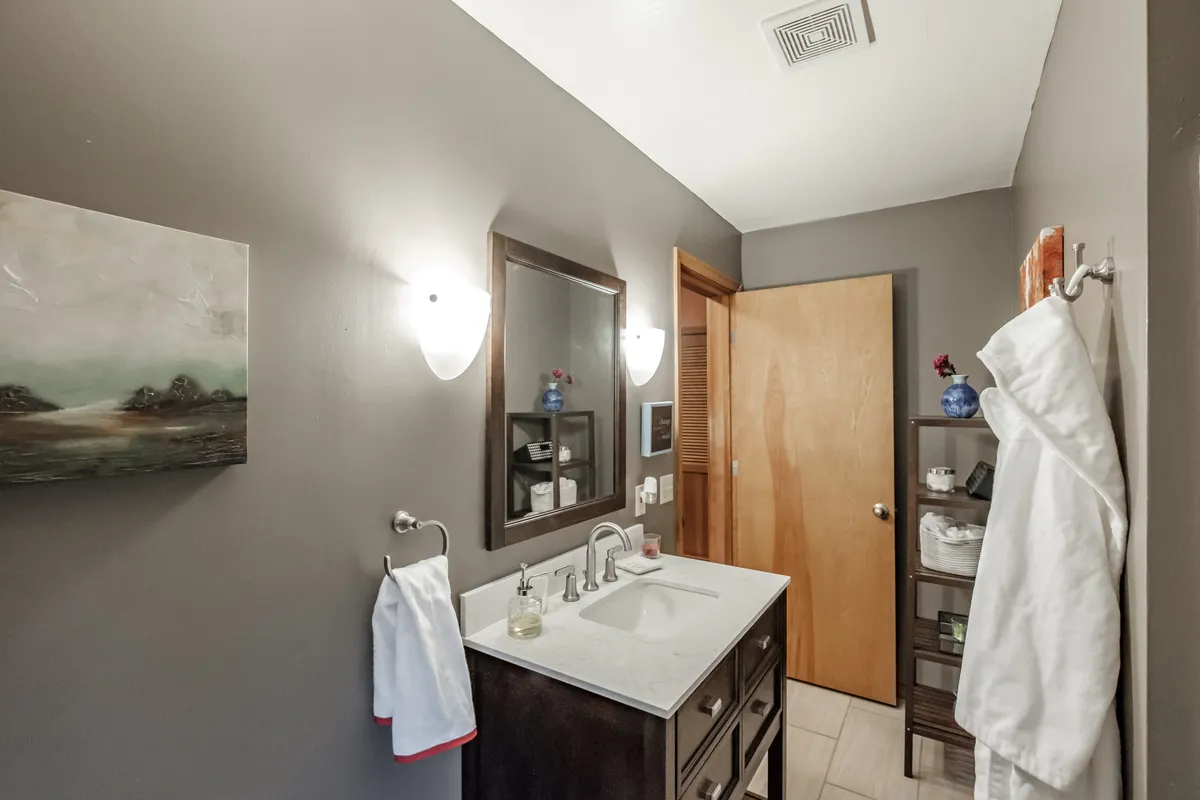The refreshed Corvallis bathroom with a dark vanity and natural light