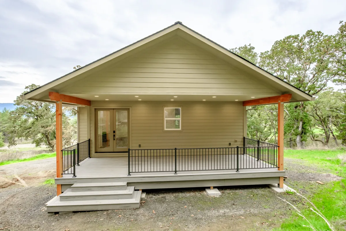 The covered back porch with cedar posts and black railing