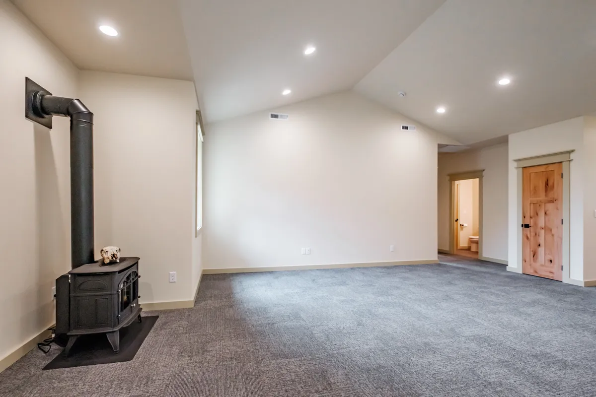 Living and dining area with a wood stove and French doors
