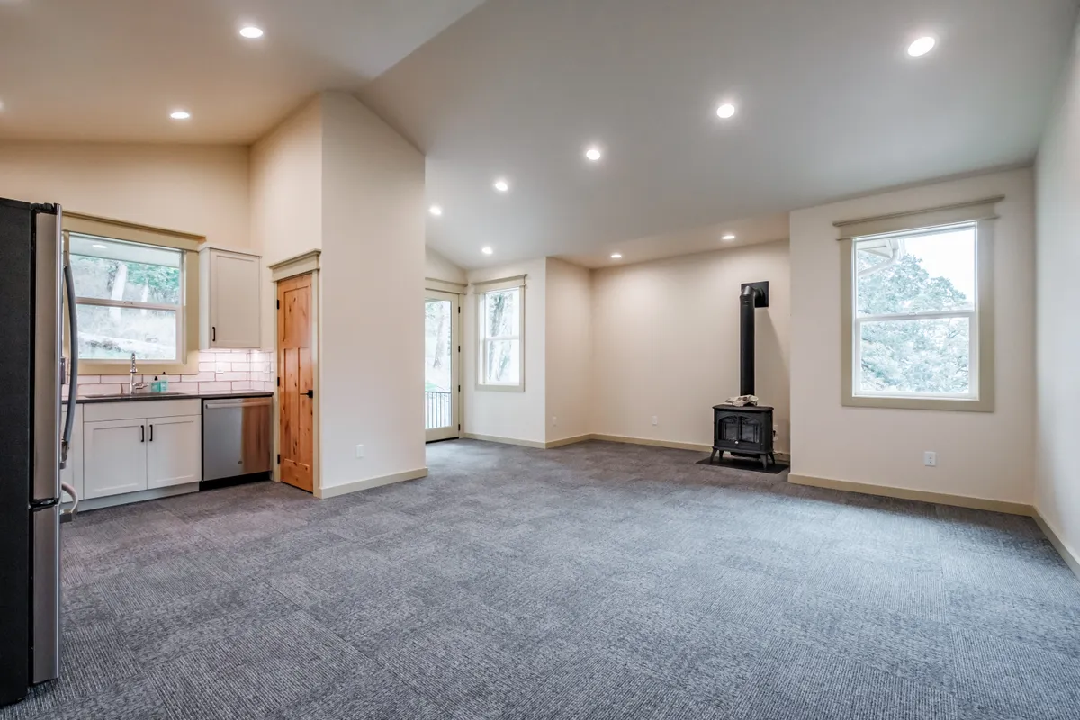 Living and dining area with a wood stove and French doors