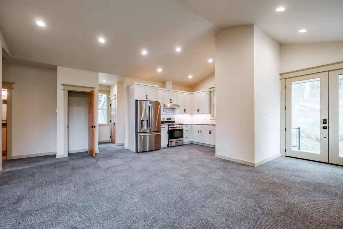 Living and dining area with a wood stove and French doors