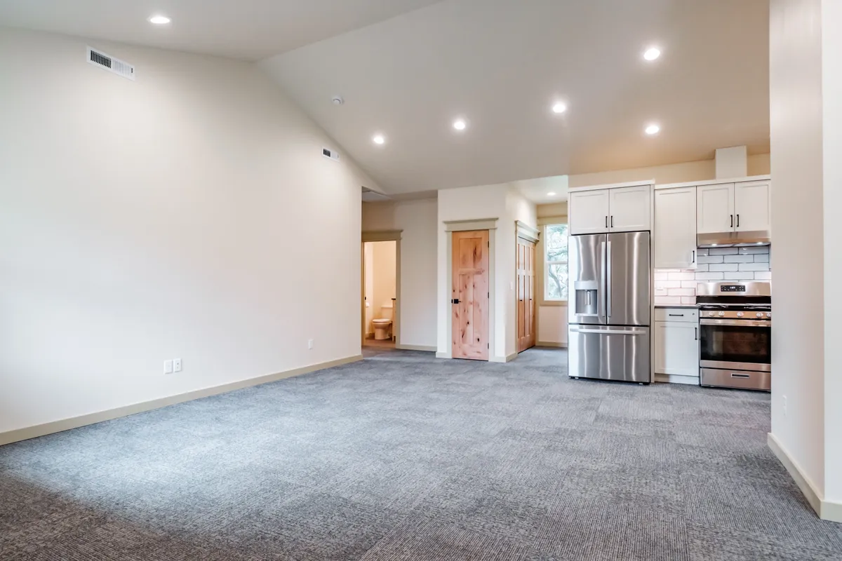 Living and dining area with a wood stove and French doors