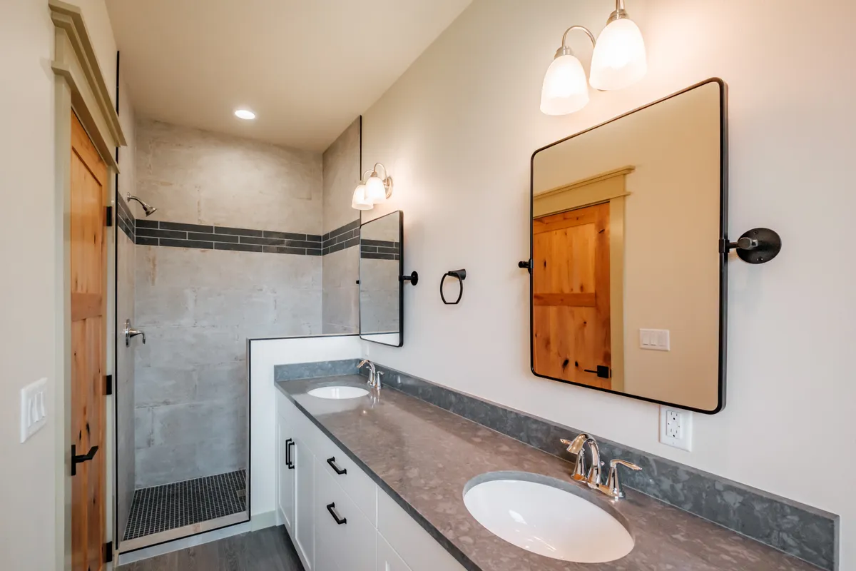 Bathrooms with tiled tub surrounds and dark counters