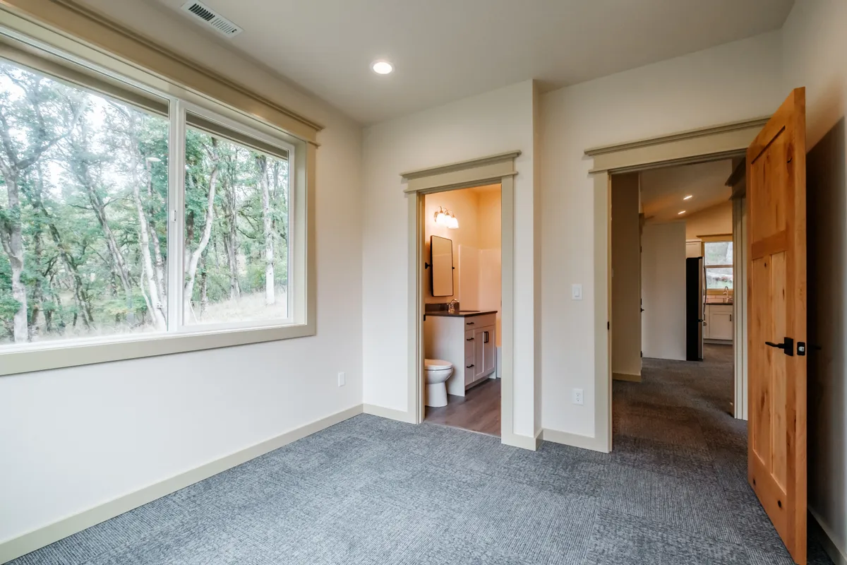Bathrooms with tiled tub surrounds and dark counters