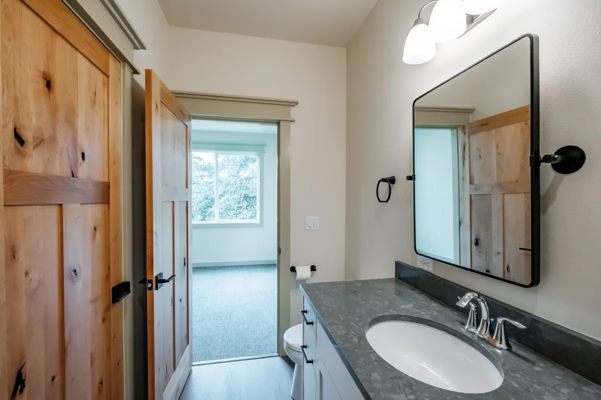 Bathrooms with tiled tub surrounds and dark counters