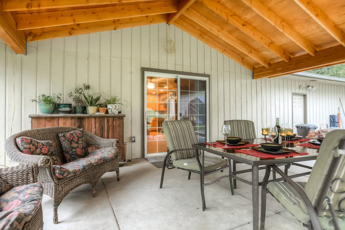 The new covered patio with cedar posts and outdoor dining