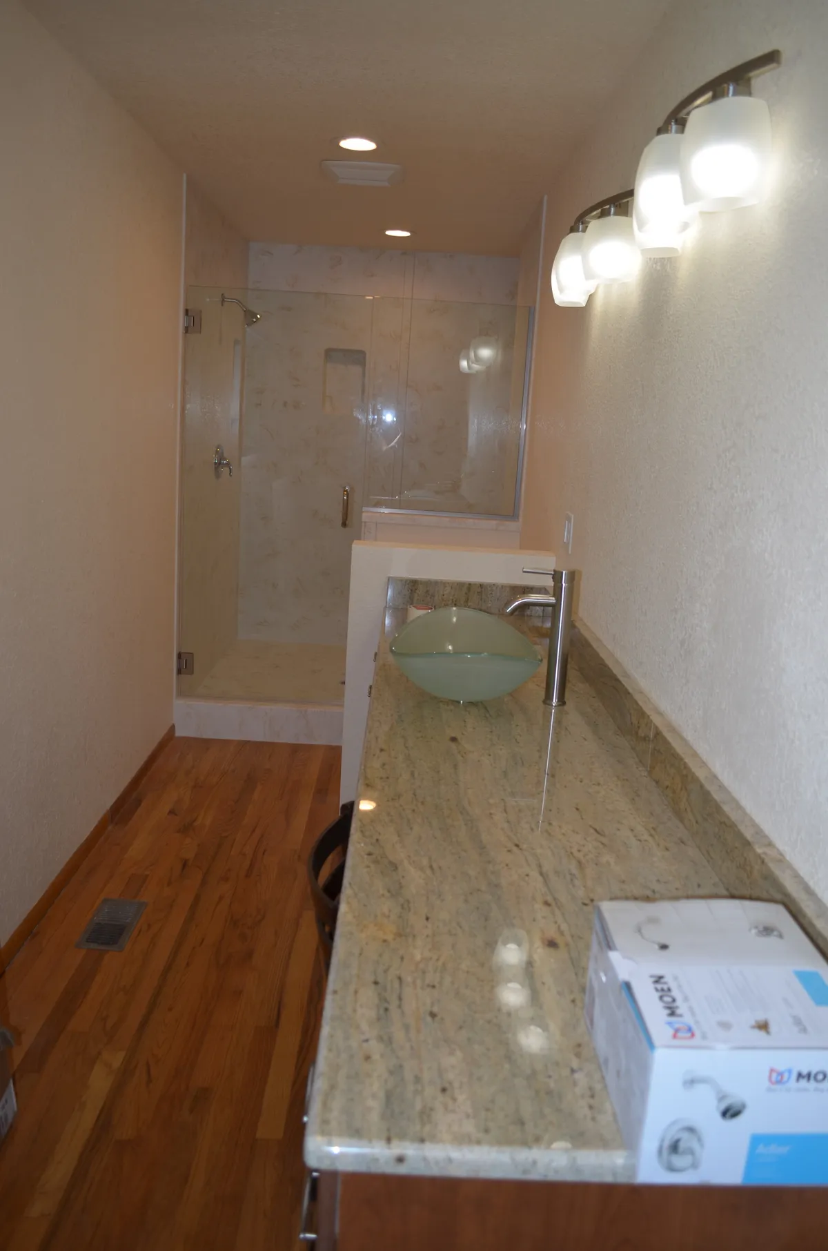 The new primary ensuite: tiled shower, granite vanity and vessel sink