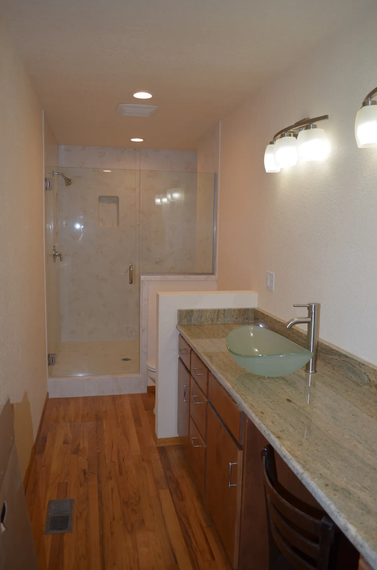 The new primary ensuite: tiled shower, granite vanity and vessel sink