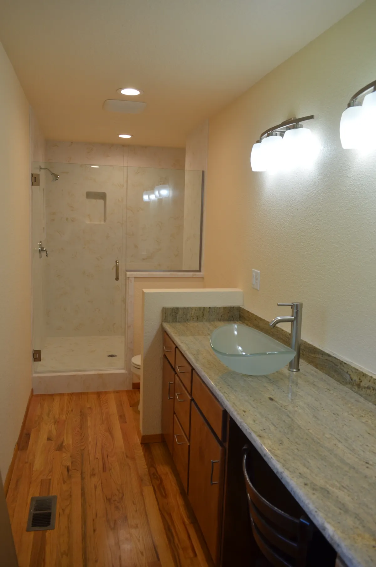 The new primary ensuite: tiled shower, granite vanity and vessel sink