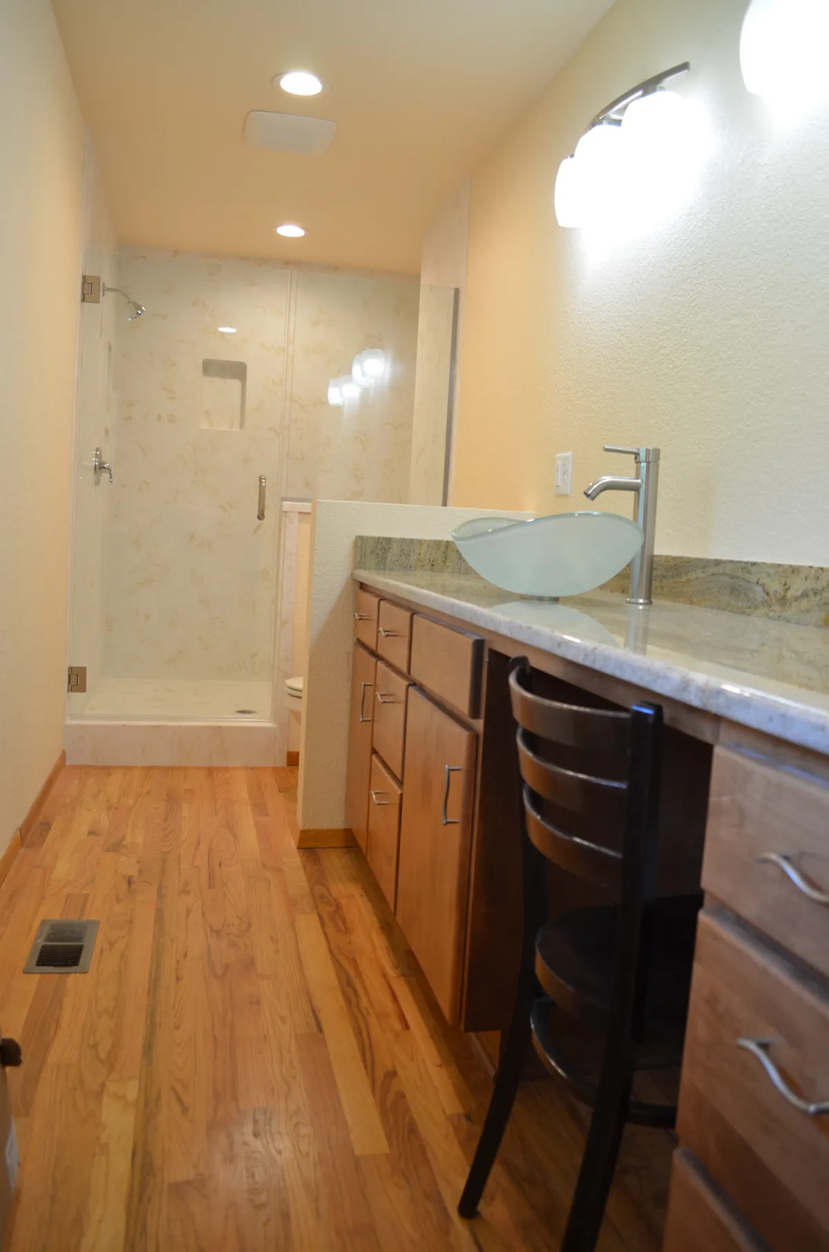 The new primary ensuite: tiled shower, granite vanity and vessel sink
