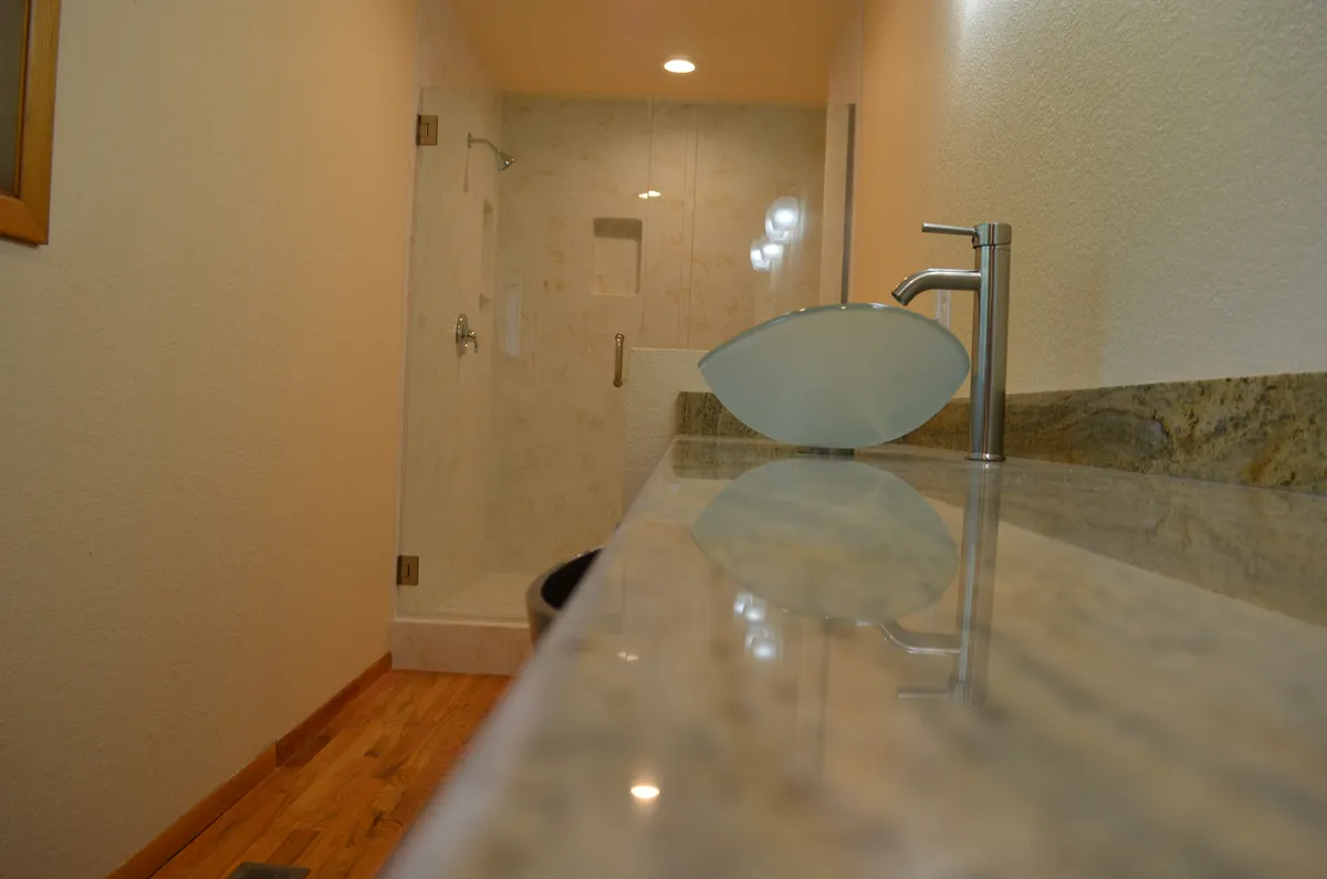 The new primary ensuite: tiled shower, granite vanity and vessel sink