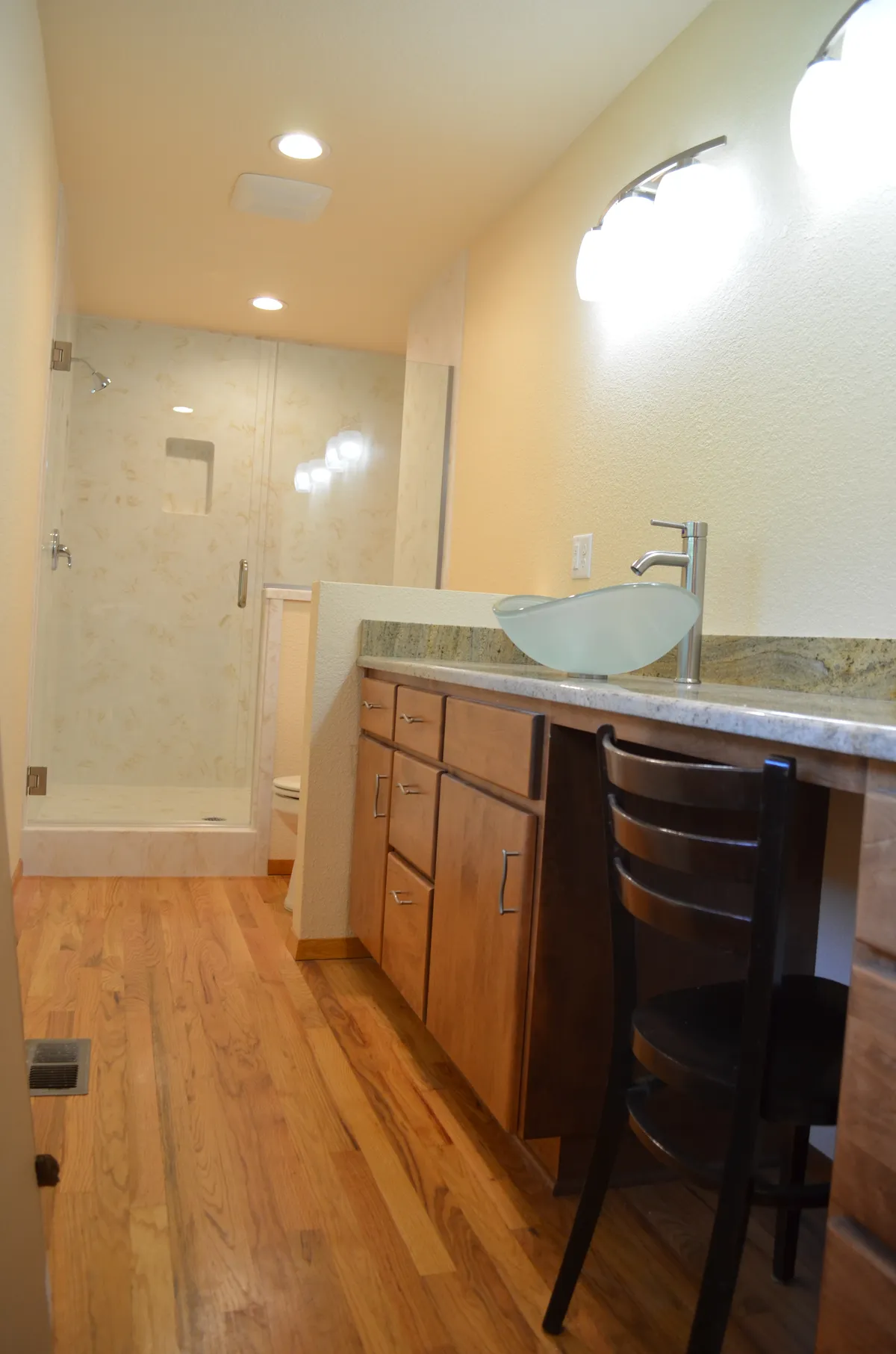 The new primary ensuite: tiled shower, granite vanity and vessel sink