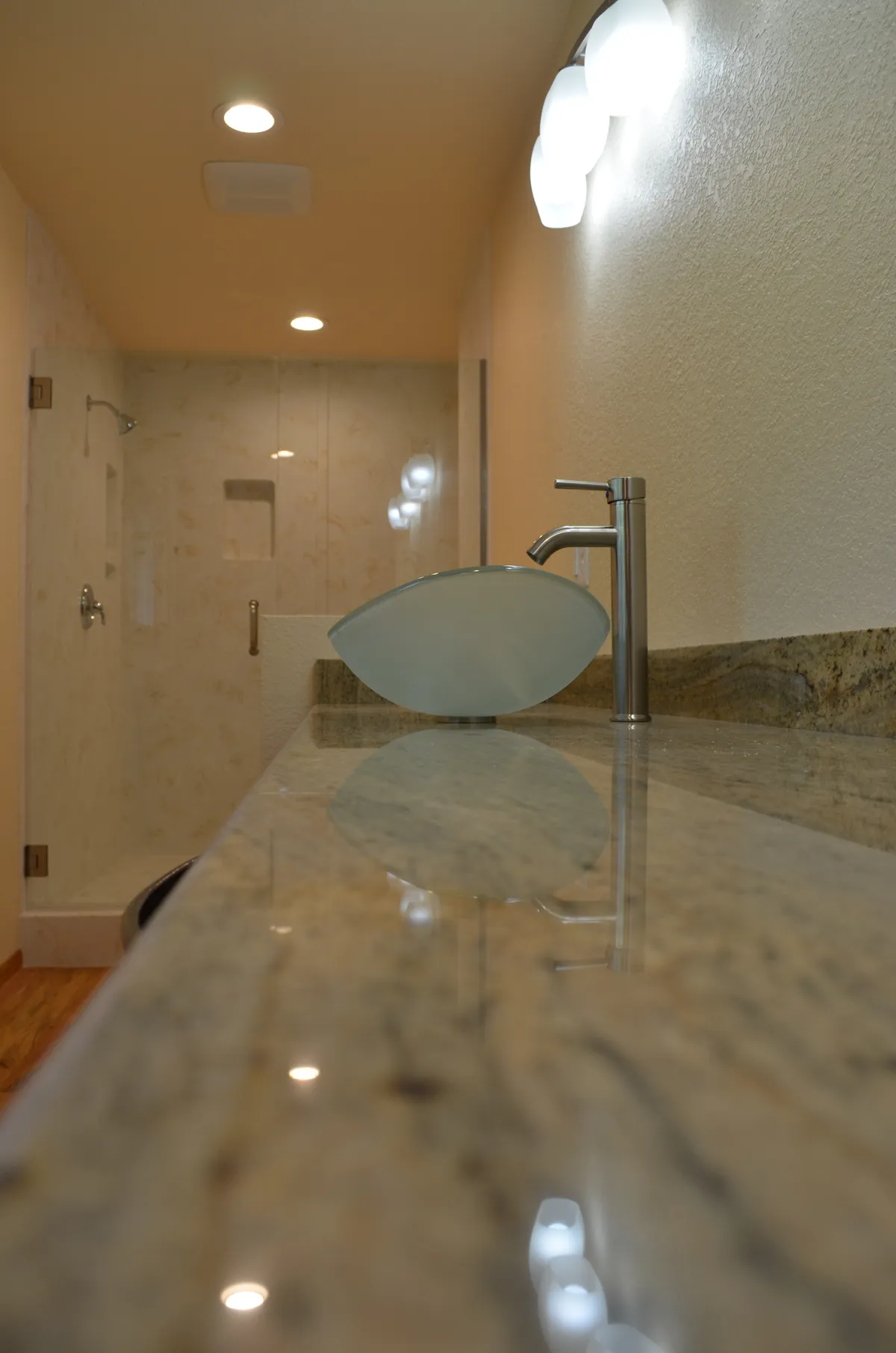 The new primary ensuite: tiled shower, granite vanity and vessel sink