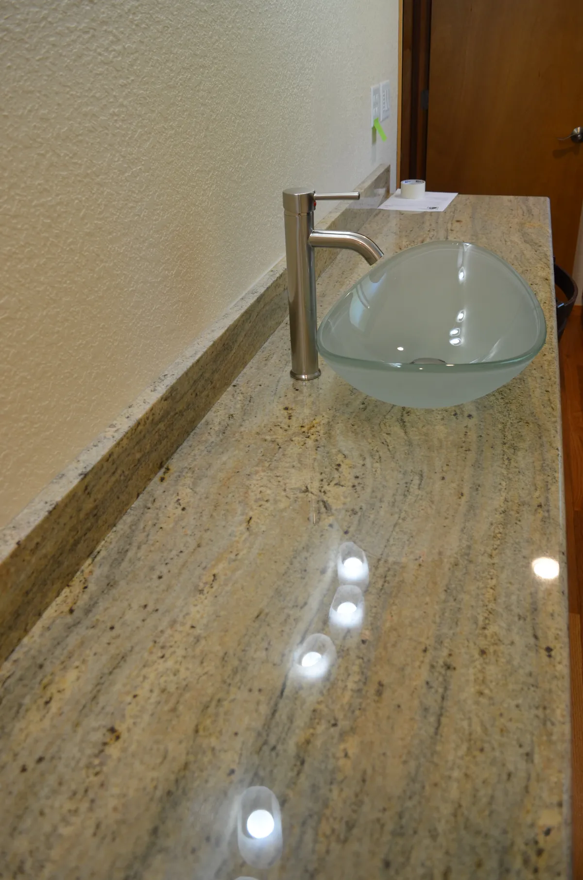 The new primary ensuite: tiled shower, granite vanity and vessel sink