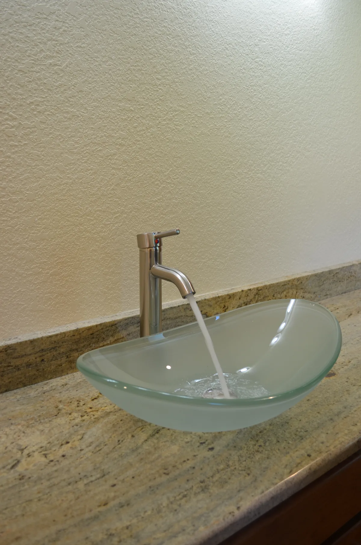 The new primary ensuite: tiled shower, granite vanity and vessel sink