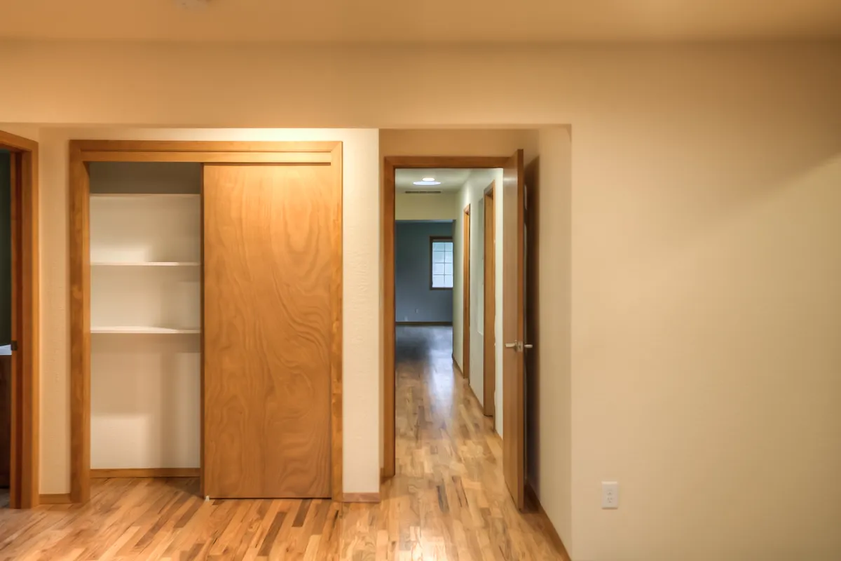 The new primary bedroom with hardwood floors that match the original house