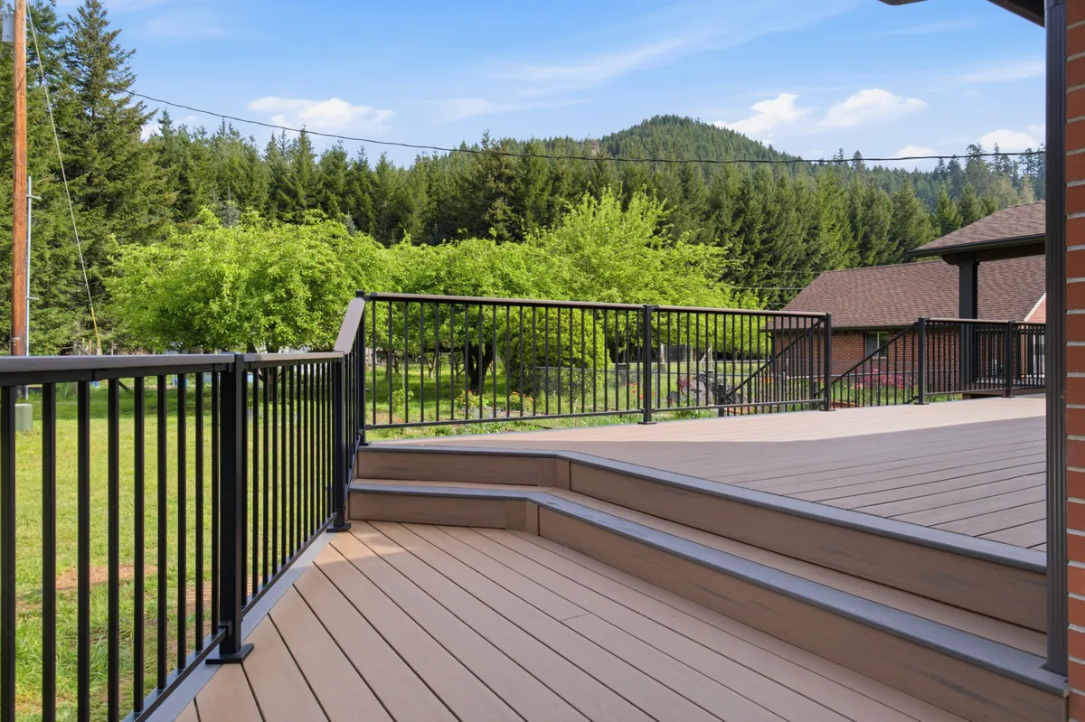 The new deck running along the brick house, looking out over the property