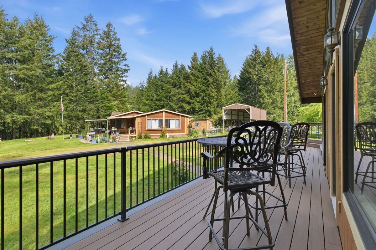 The new deck running along the brick house, looking out over the property