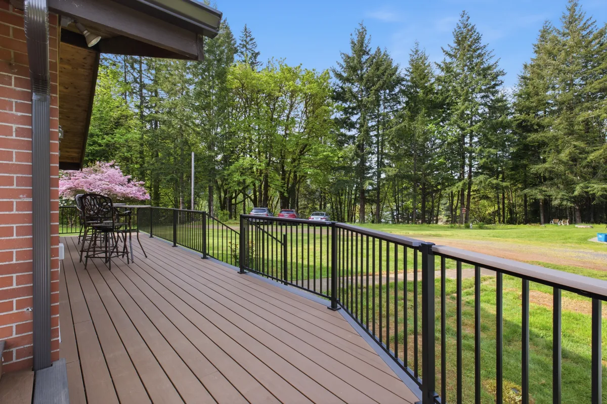 The new deck running along the brick house, looking out over the property