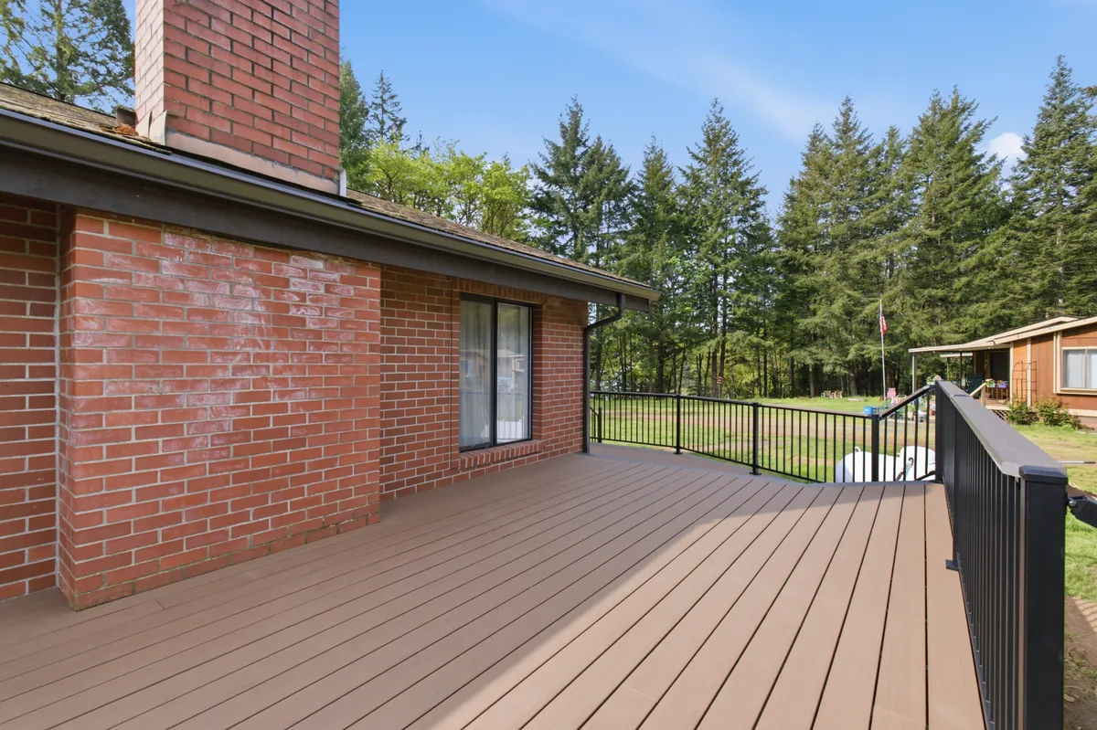 The new deck running along the brick house, looking out over the property