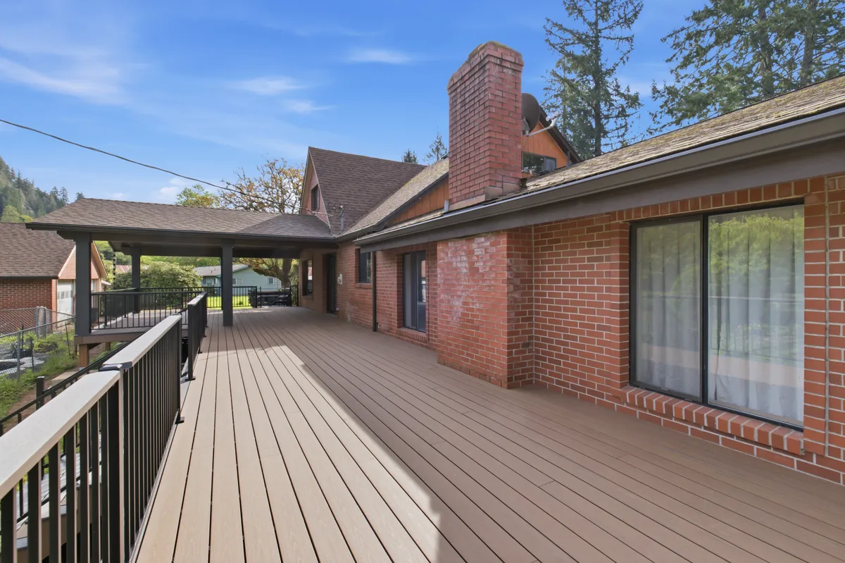 The new deck running along the brick house, looking out over the property