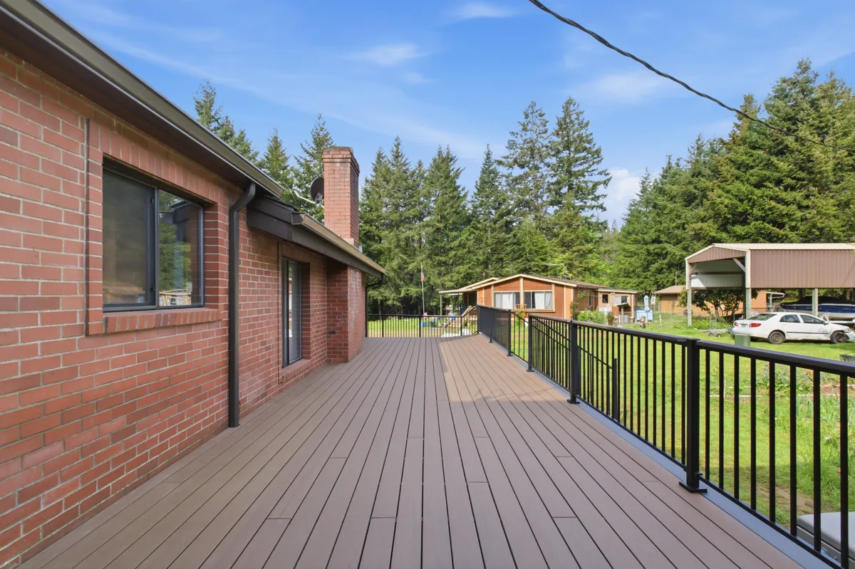 The new deck running along the brick house, looking out over the property