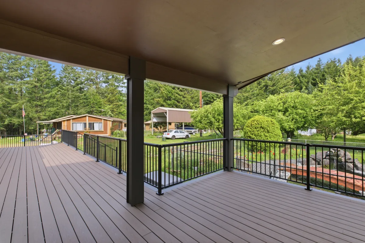The covered deck with recessed lights and a ceiling fan