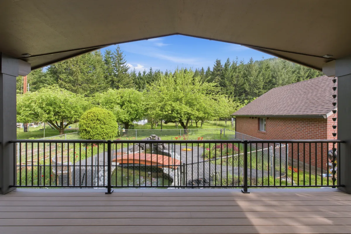 The covered deck with recessed lights and a ceiling fan