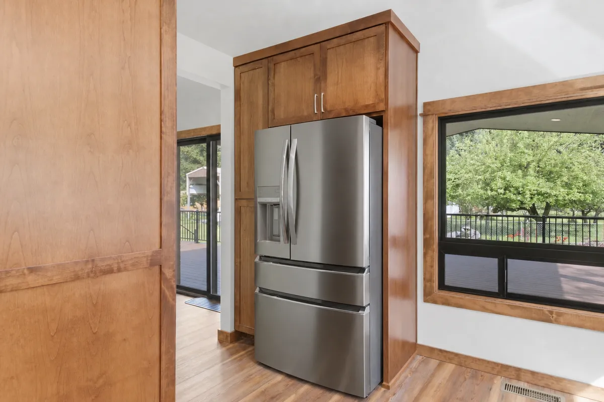 Kitchen refrigerator wall and walk-in pantry