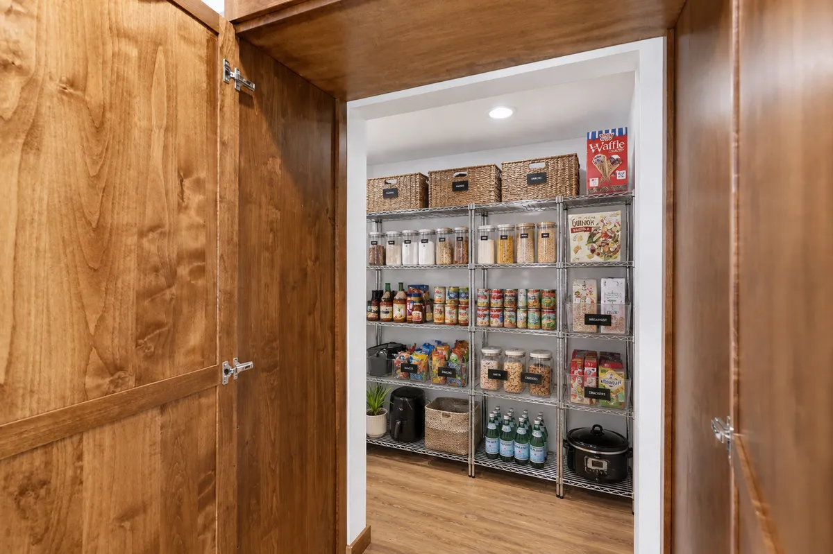 Kitchen refrigerator wall and walk-in pantry