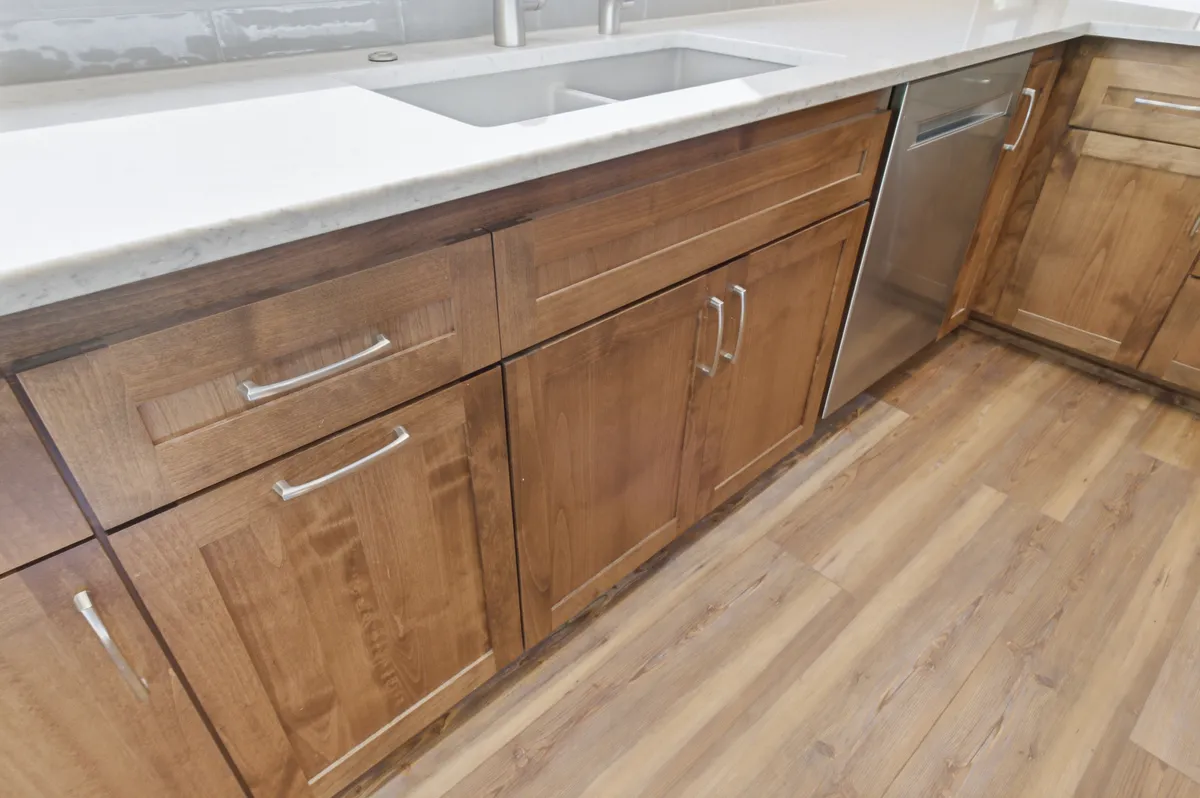 The kitchen: alder cabinets, white quartz counters and a picture window