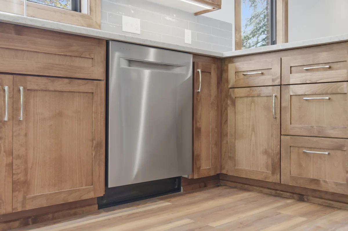 The kitchen: alder cabinets, white quartz counters and a picture window