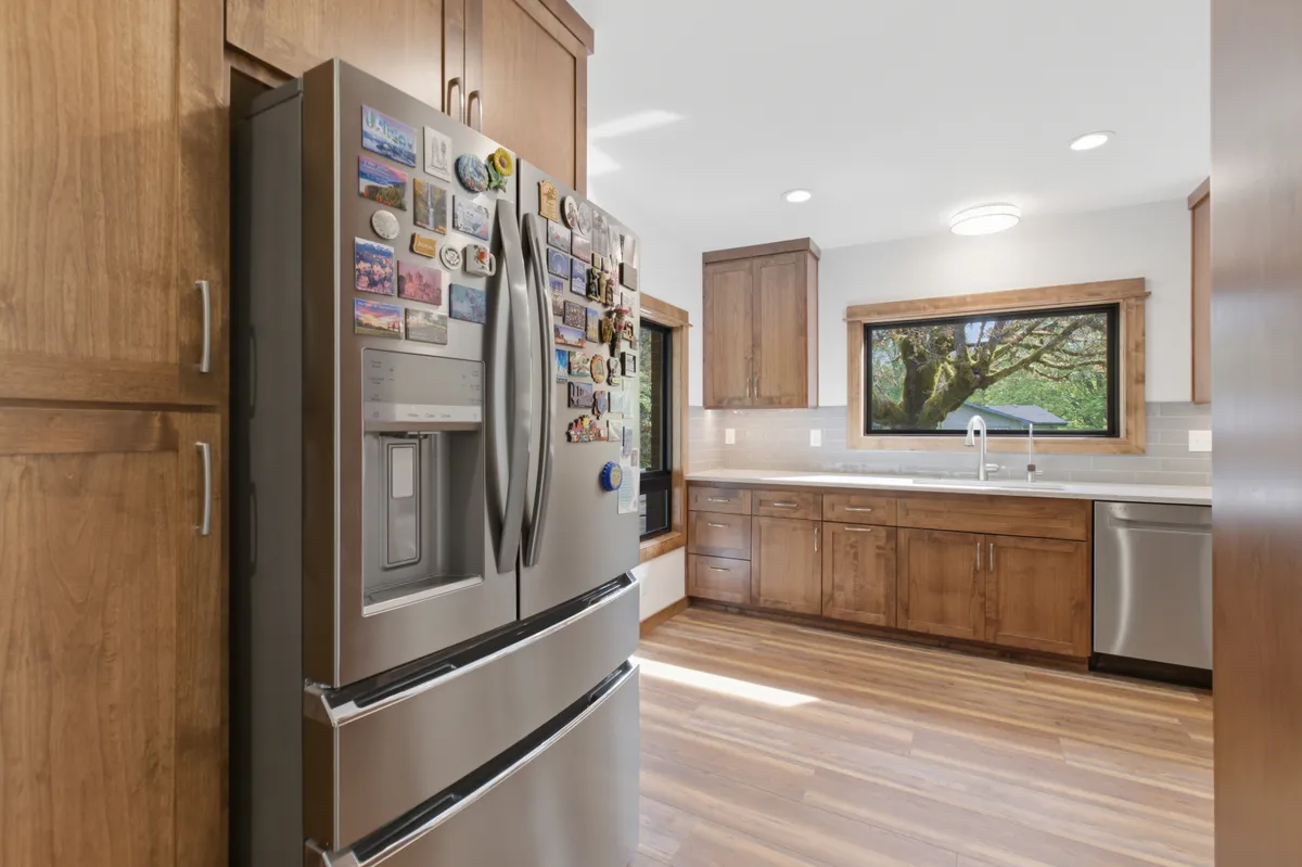 The kitchen: alder cabinets, white quartz counters and a picture window