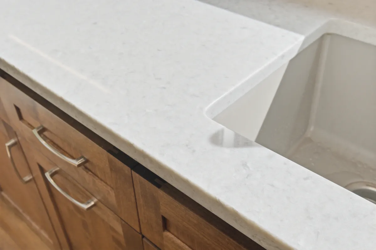 The kitchen: alder cabinets, white quartz counters and a picture window