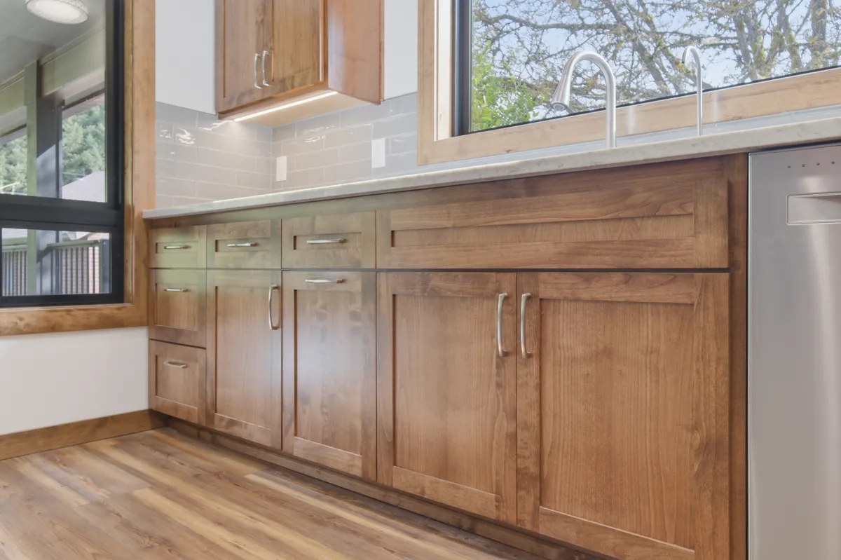 The kitchen: alder cabinets, white quartz counters and a picture window