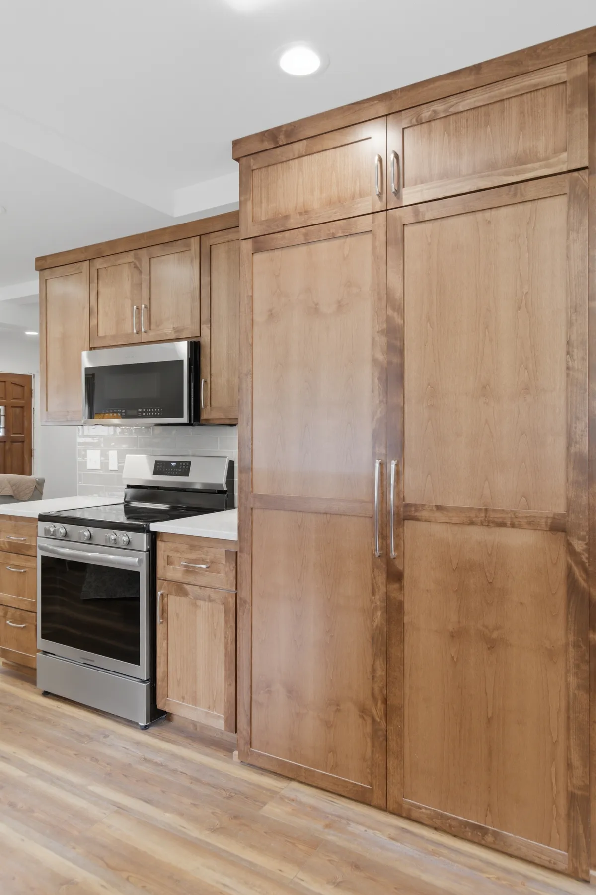 Tall pantry cabinets beside the range