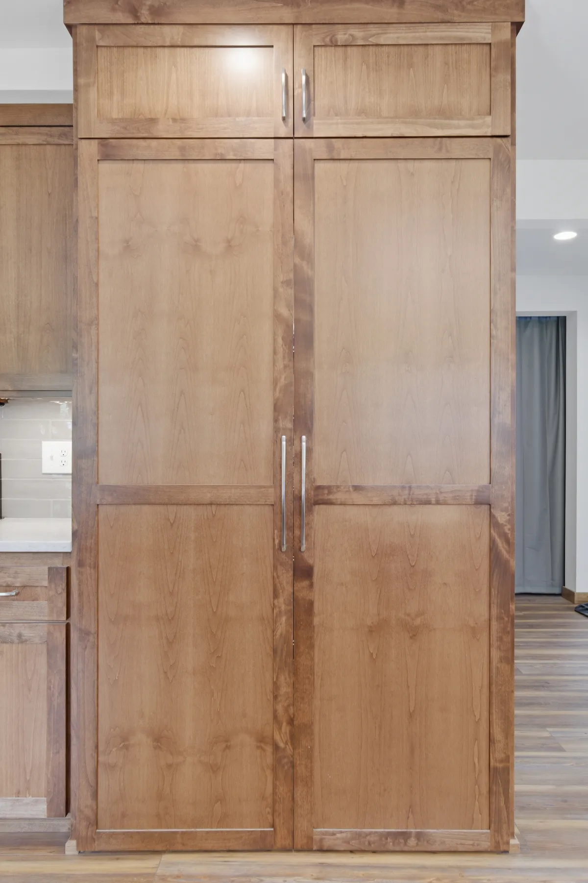 Tall pantry cabinets beside the range