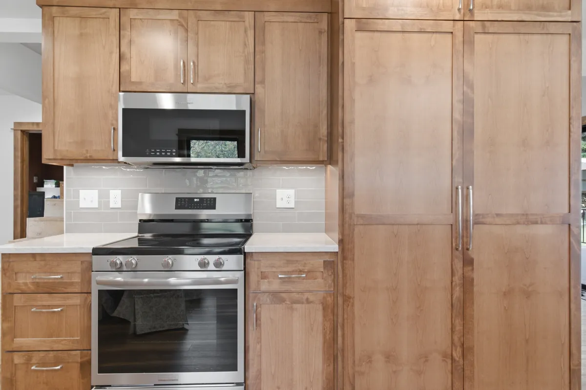 Tall pantry cabinets beside the range