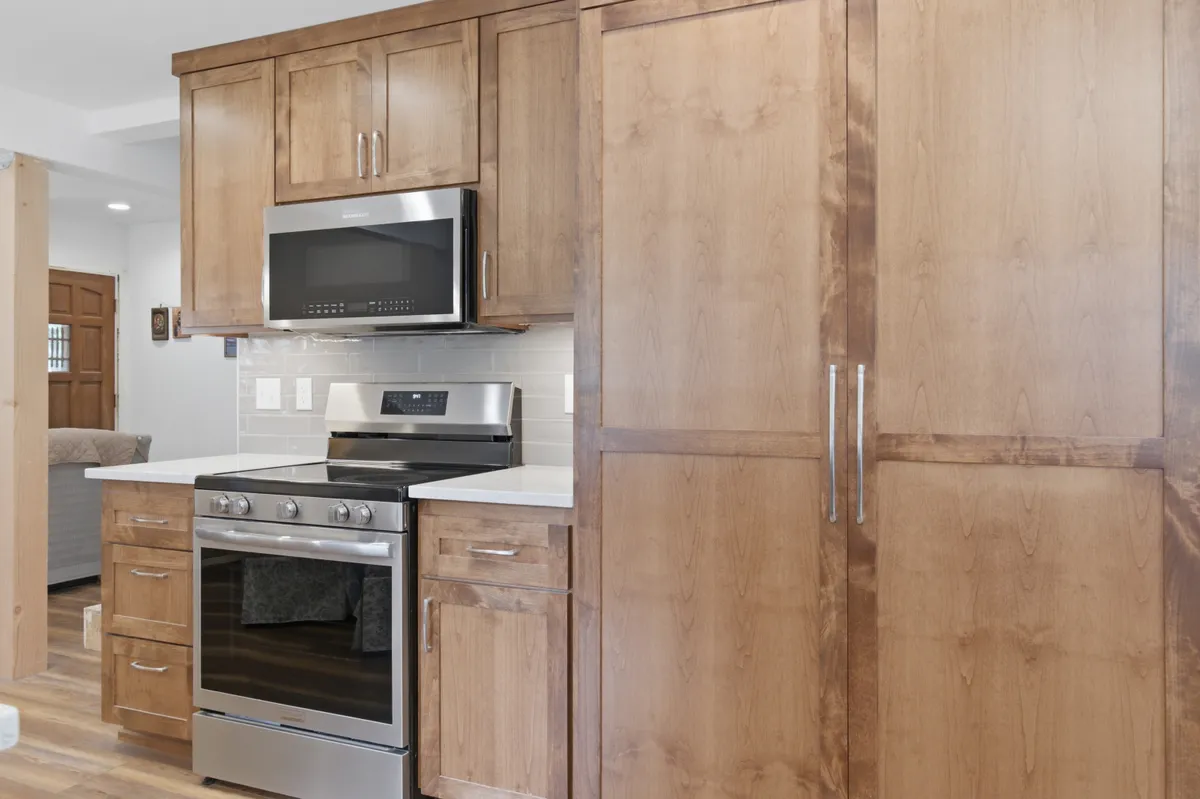 Tall pantry cabinets beside the range
